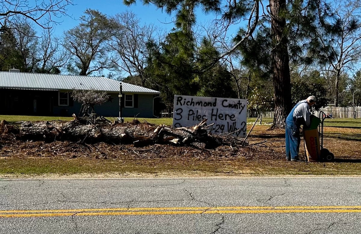 On Skinner Mill Road a resident has a sign asking why the three piles of debris have not been picked up. Staff photo by Susan McCord