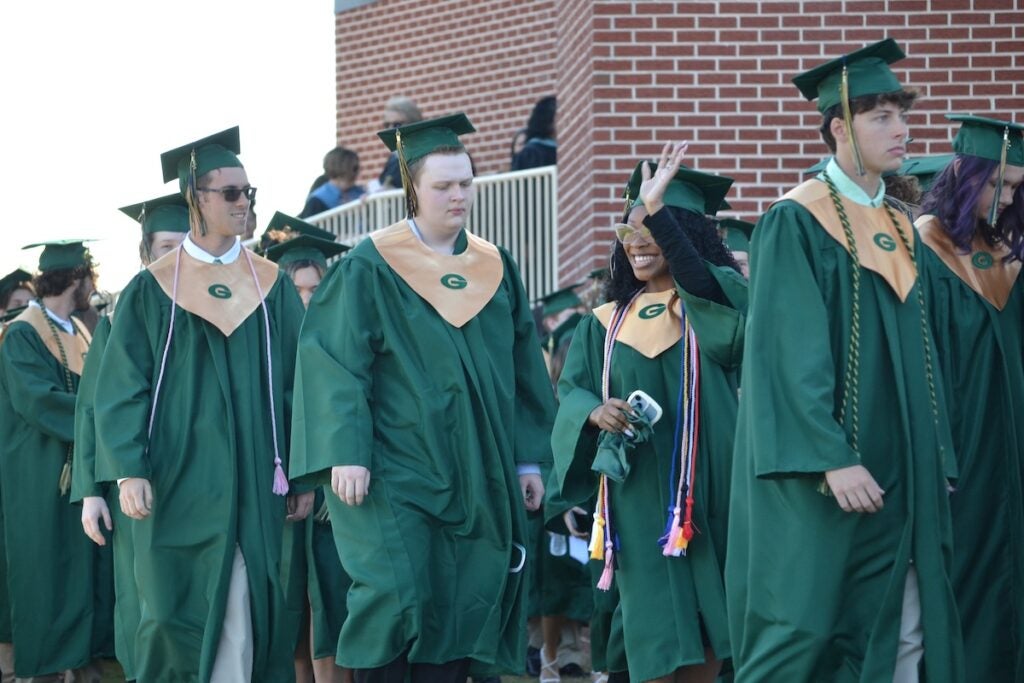 Graduates were all smiles as they walked into graduation. Staff photo by Stephanie Hill