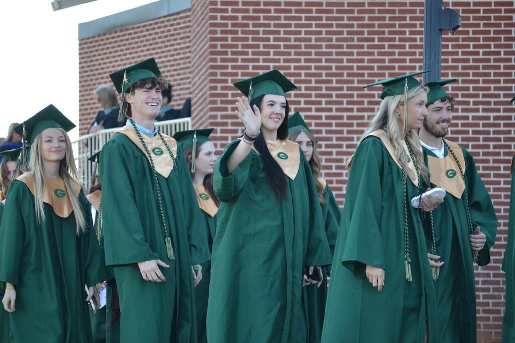 Graduates were all smiles as they walked into graduation. Staff photo by Stephanie Hill