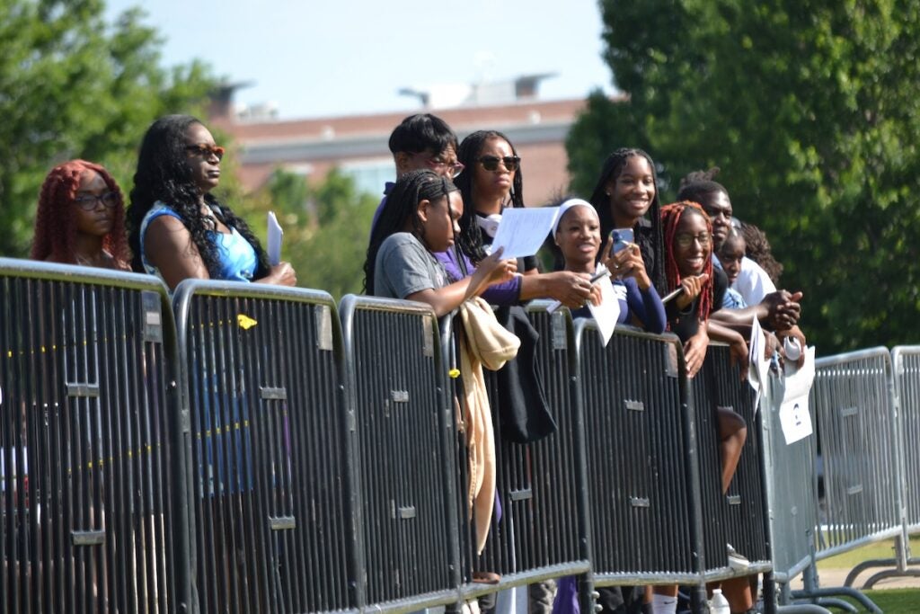 Family and friends lined the fence at Evans Towne Center Park to cheer for their graduate. Staff photo by Stephanie Hill