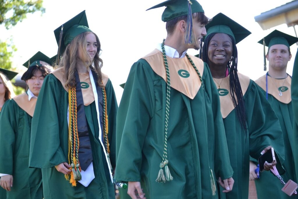 Graduates were all smiles as they walked into graduation. Staff photo by Stephanie Hill