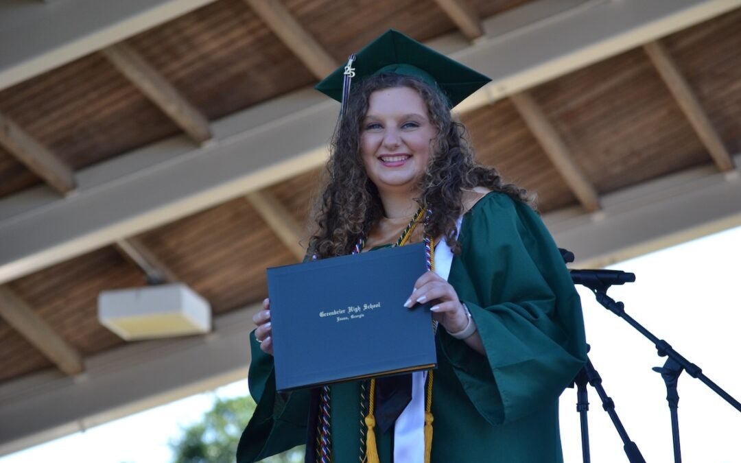 Greenbrier High School graduate Katie Grace Dailey proudly shows off her diploma at the commencement ceremony on Thursday, May 22. Staff photo by Stephanie Hill