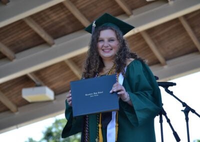 Greenbrier High School graduate Katie Grace Dailey proudly shows off her diploma at the commencement ceremony on Thursday, May 22. Staff photo by Stephanie Hill