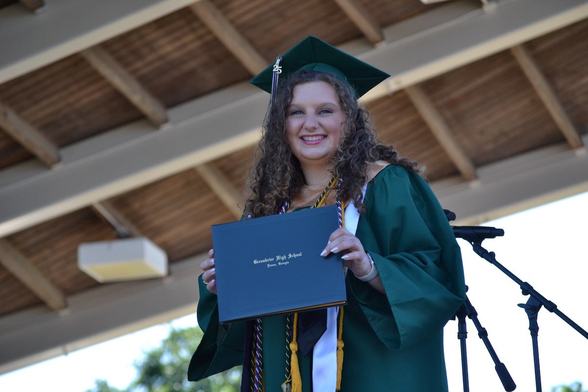 Greenbrier High School graduate Katie Grace Dailey proudly shows off her diploma at the commencement ceremony on Thursday, May 22. Staff photo by Stephanie Hill