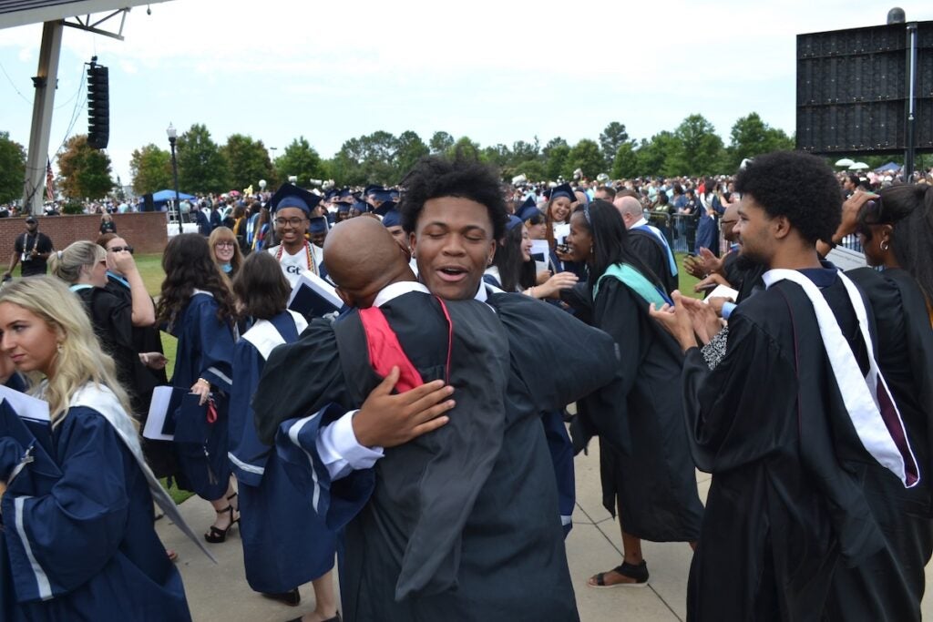 Graduates hugged their teachers following the Grovetown High School commencement ceremony. Staff photo by Stephanie Hill