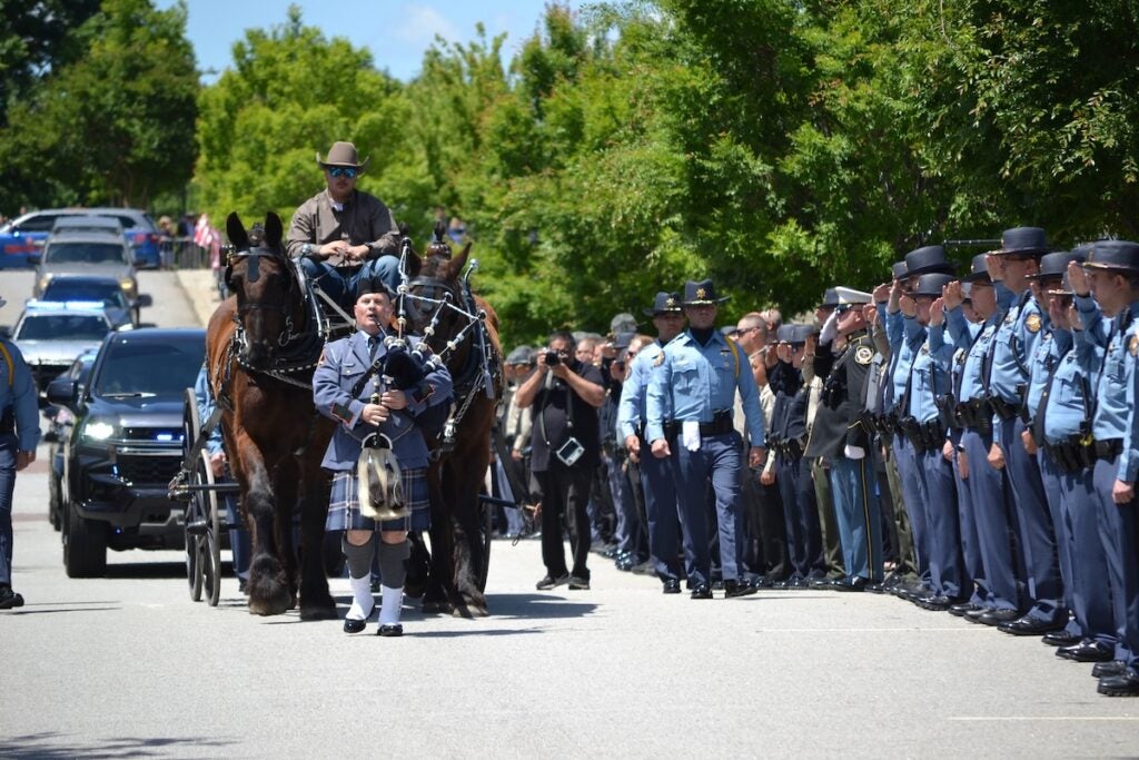 The body of Deputy Brandon Sikes was brought to the Performing Arts Center in a horse and carriage. Staff photo by Stephanie Hill
