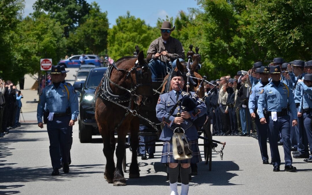The body of Deputy Brandon Sikes was brought to the Performing Arts Center in a horse and carriage. Staff photo by Stephanie Hill