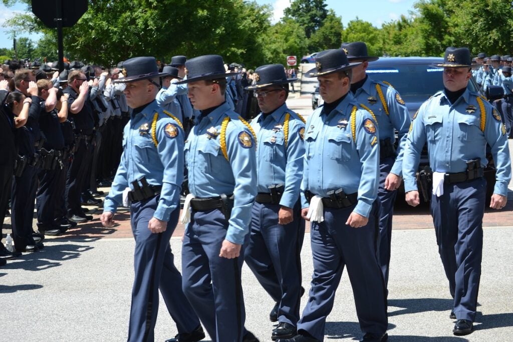 Deputies walk in the funeral procession of Deputy Brandon Sikes. Staff photo by Stephanie Hill