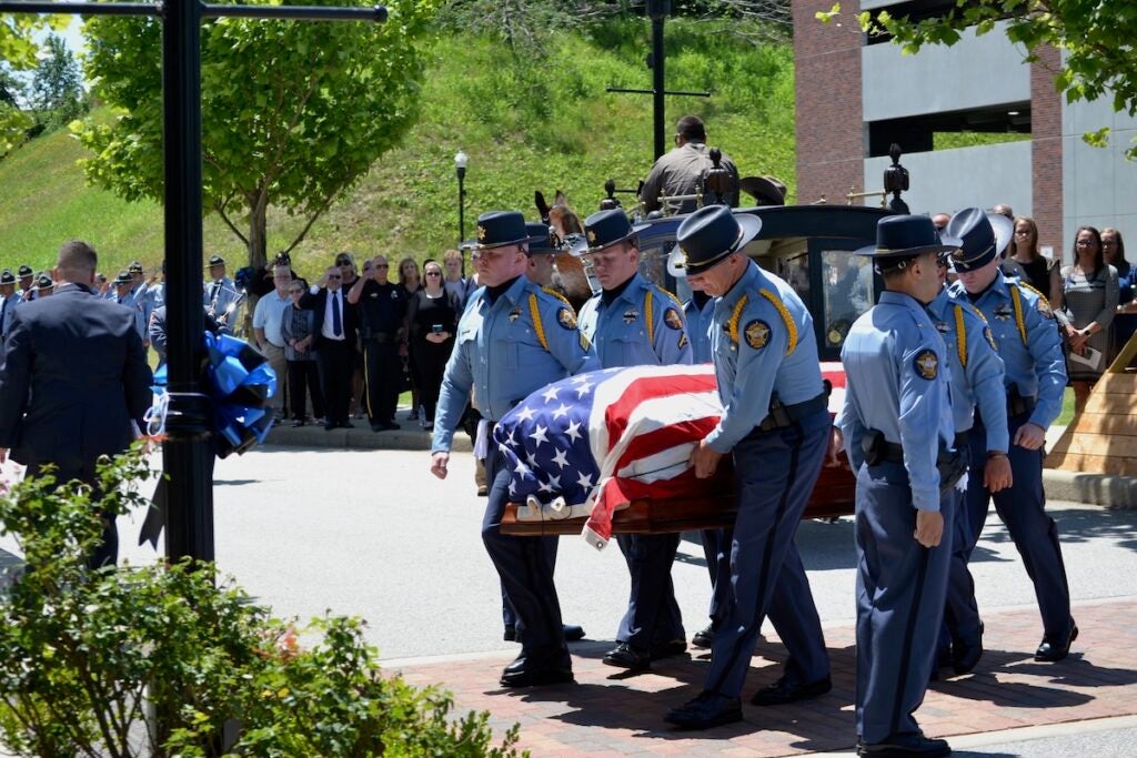 Deputies carry in the body of Deputy Brandon Sikes to the Performing Arts Center. Staff photo by Stephanie Hill