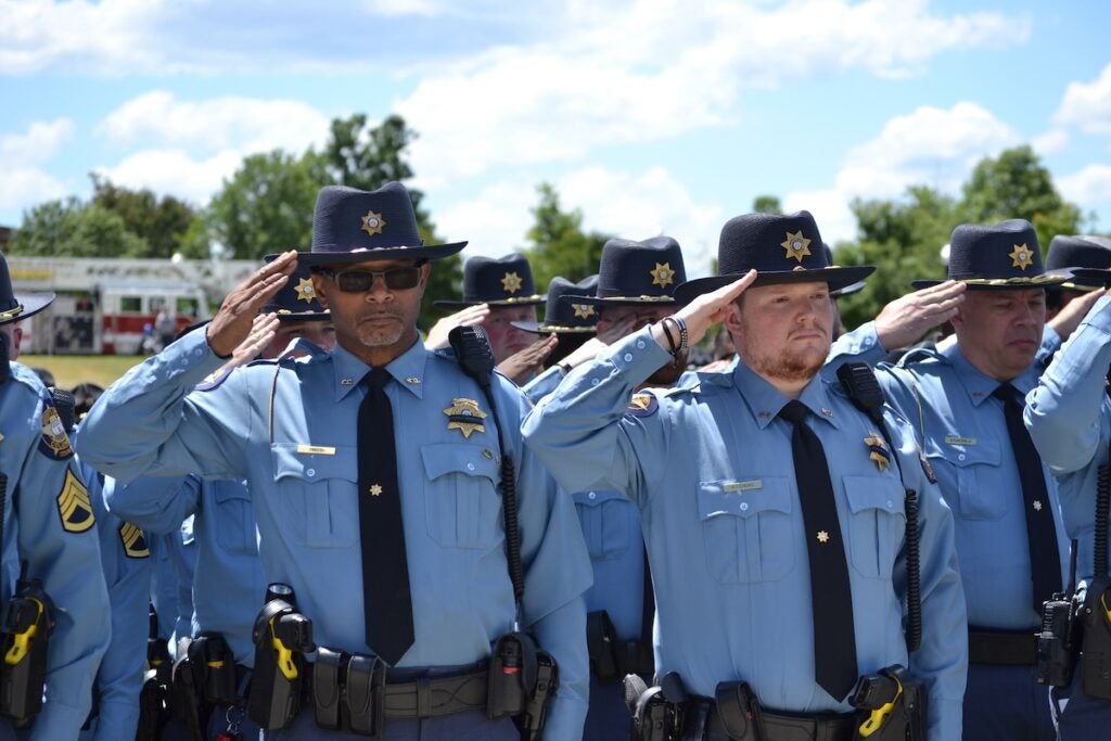 Deputies salute ahead of the 21-gun salute at the funeral of Deputy Brandon Sikes on Monday, May 5. Staff photo by Stephanie Hill