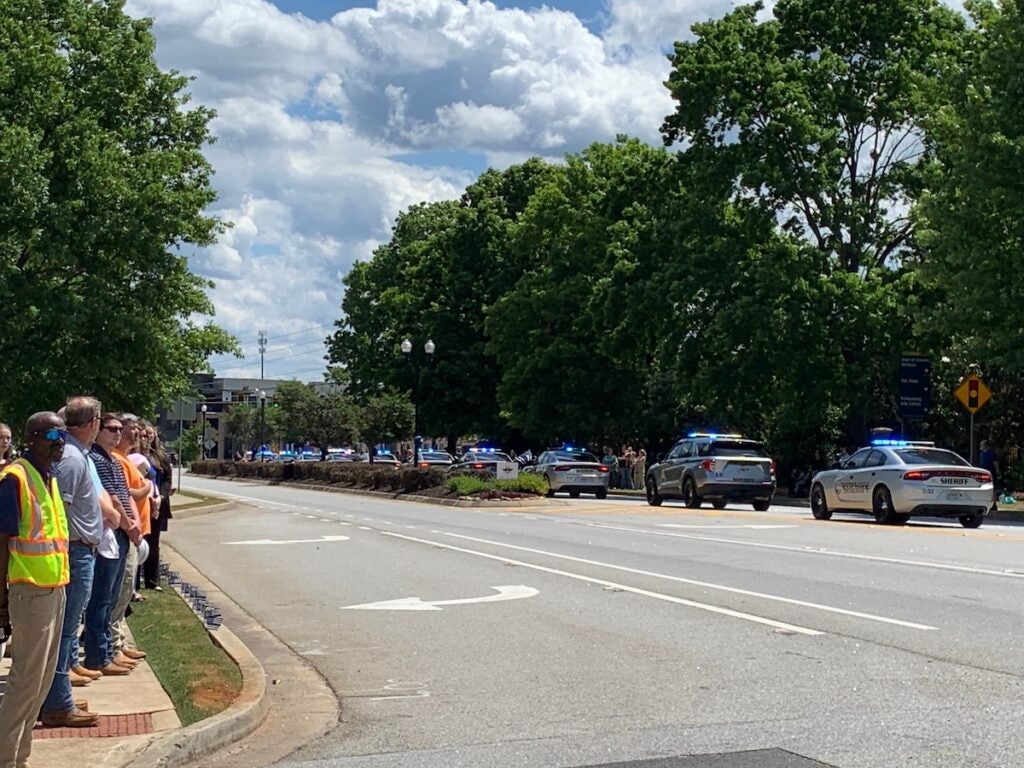 Crowds look on as Columbia County officers follow representatives of law enforcement across Georgia. Staff photo by Scott Hudson