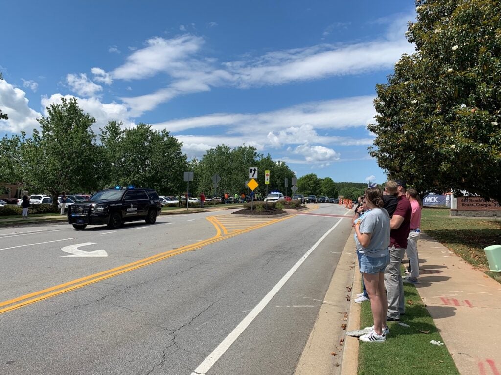 Crowds line up on Ronald Reagan Drive as the law enforcement procession makes its way to the Performing Arts Center. Staff photo by Scott Hudson