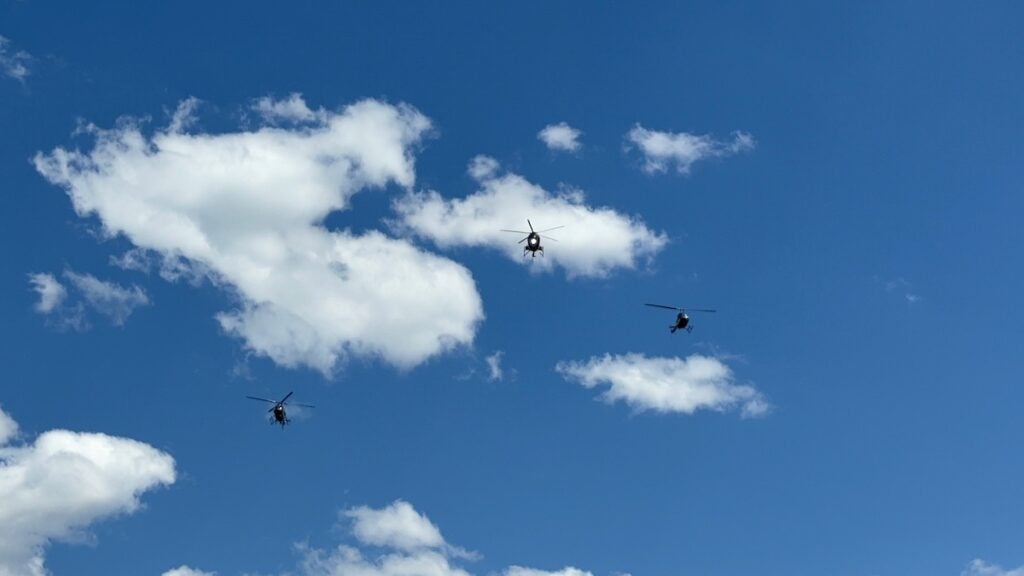 A flyover with three helicopters was conducted at the funeral for Deputy Brandon Sikes. One flew away to represent the fallen deputy. Staff photo by Stephanie Hill
