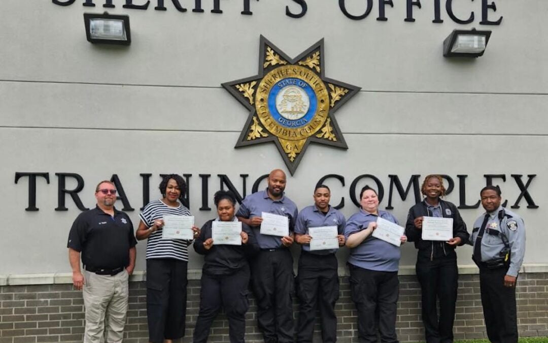 Pictured (left to right): Sergeant Michael Trap, followed by graduates Detra Willis, Gloria Chin, Terrell Mack, Isiah Williams, Michelle Johnson, Jasmine Donahoo, and Captain Kenneth Daniels offering congratulations. Photo courtesy Richmond County Sheriff's Office.