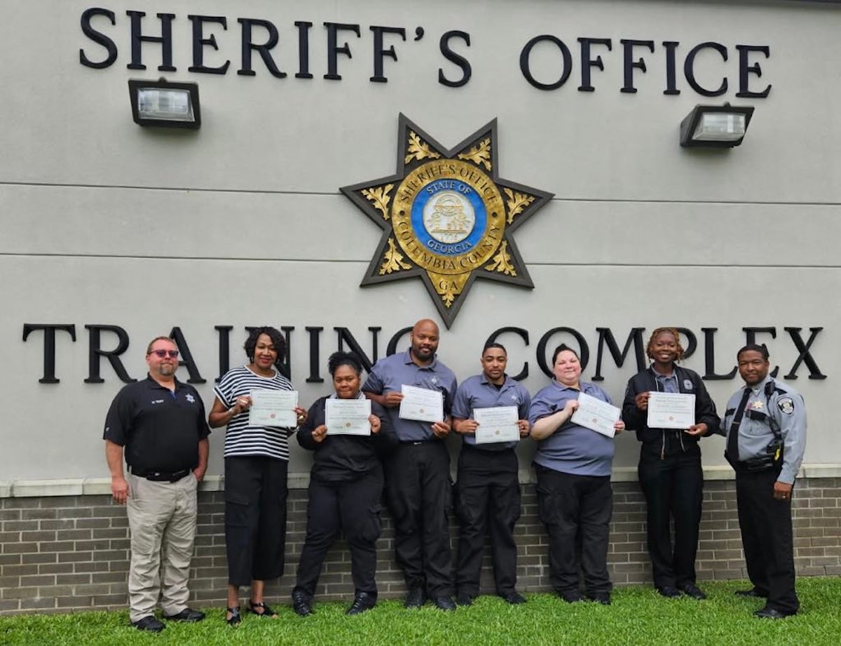 Pictured (left to right): Sergeant Michael Trap, followed by graduates Detra Willis, Gloria Chin, Terrell Mack, Isiah Williams, Michelle Johnson, Jasmine Donahoo, and Captain Kenneth Daniels offering congratulations. Photo courtesy Richmond County Sheriff's Office.