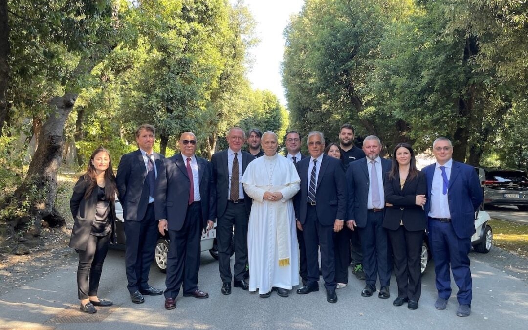 Pope Leo with representatives from Club Car and Exelentia, along with engineers and technicians who worked on the project. Photo courtesy Club Car