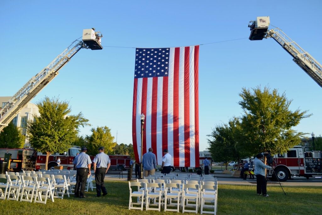 An American Flag was flown at the 9/11 Memorial Stair Climb with Remembrance Ceremony on Thursday. Staff photo by Stephanie Hill
