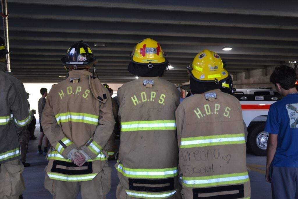 Evans High School students in the firefighter pathway listen to instructions before the start of the stair climb. Staff photo by Stephanie Hill