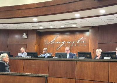 Interim General Counsel Jim Plunkett, lower left, speaks to Augusta commissioners and Mayor Garnett Johnson during Tuesday's meeting.