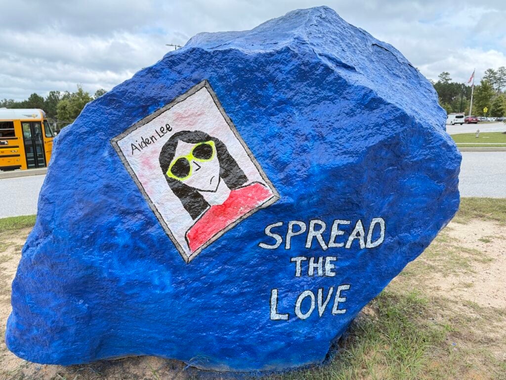 A rock in front of Harlem Middle School is painted in remembrance of Aiden Lee. Staff photo by Drew Wall