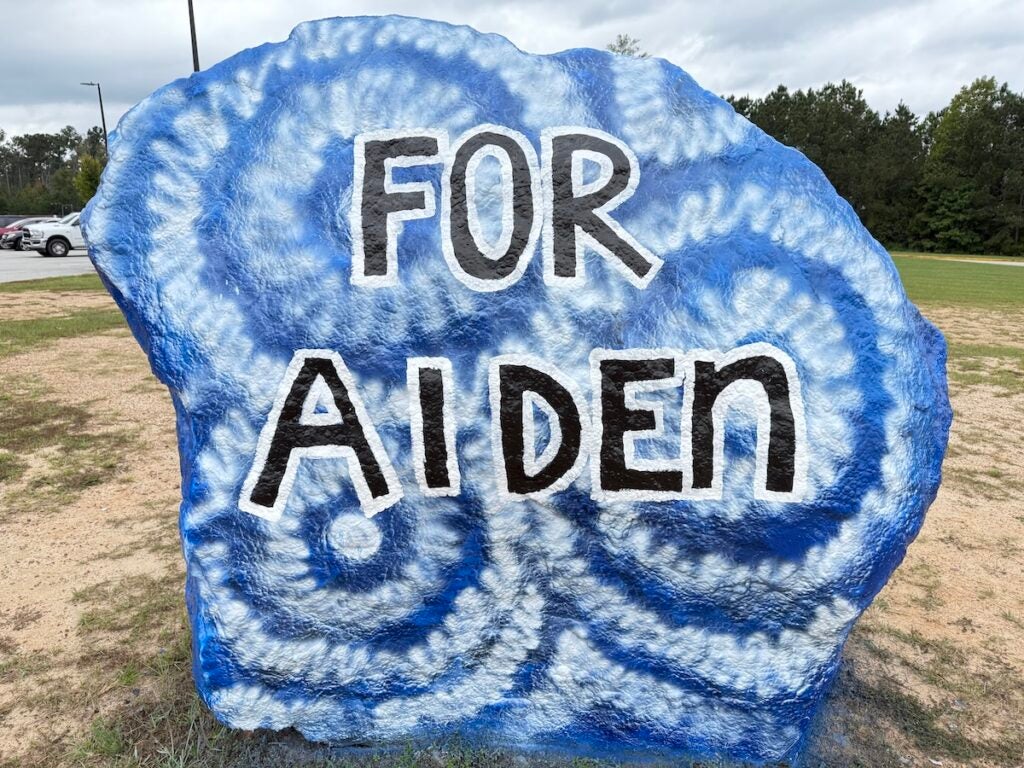 A rock in front of Harlem Middle School is painted in remembrance of Aiden Lee. Staff photo by Drew Wall