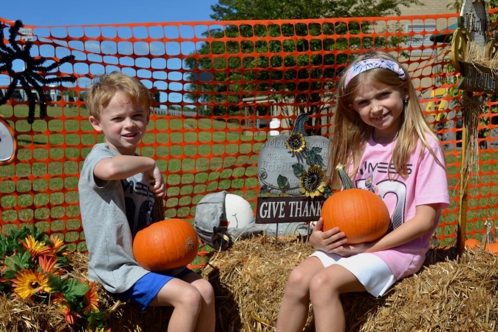 Charlotte and James Watson has fun looking at all the pumpkins at Marvin United Methodist Church.