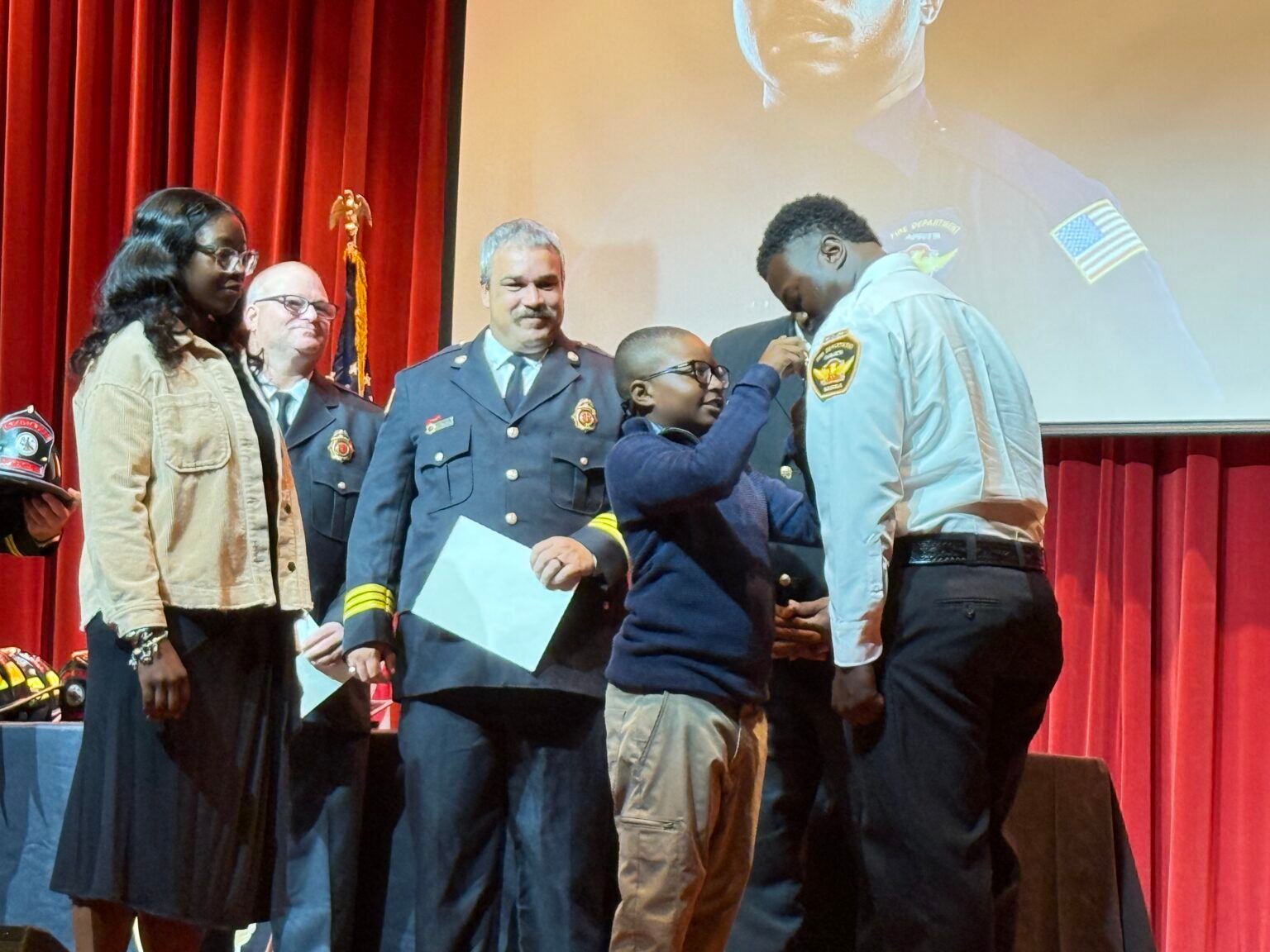Wesley Brinson pinned by his son at the firefighter graduation ceremony. Photo by Drew Wall