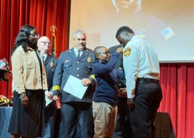 Wesley Brinson pinned by his son at the firefighter graduation ceremony. Photo by Drew Wall