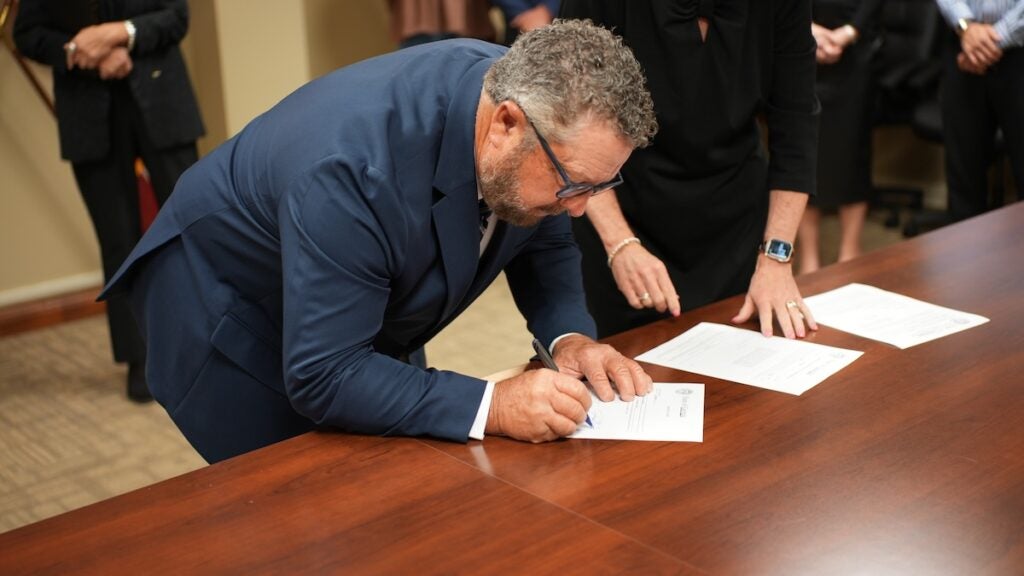 Jim Steed signs his oath of office after being sworn in by Judge Alice Padgett. Photo courtesy Columbia County