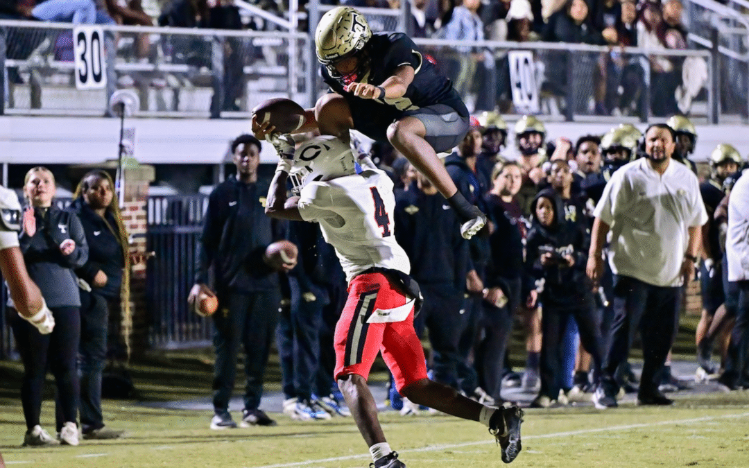 Thomson quarterback Markevion Jones (12) leaps over a Callaway defender during a GHSA Region 2A second round playoff game in Thomson, Ga., on Friday, November 21, 2025. (photo by Rob Davis)