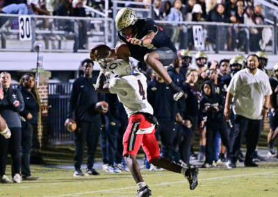 Thomson quarterback Markevion Jones (12) leaps over a Callaway defender during a GHSA Region 2A second round playoff game in Thomson, Ga., on Friday, November 21, 2025. (photo by Rob Davis)