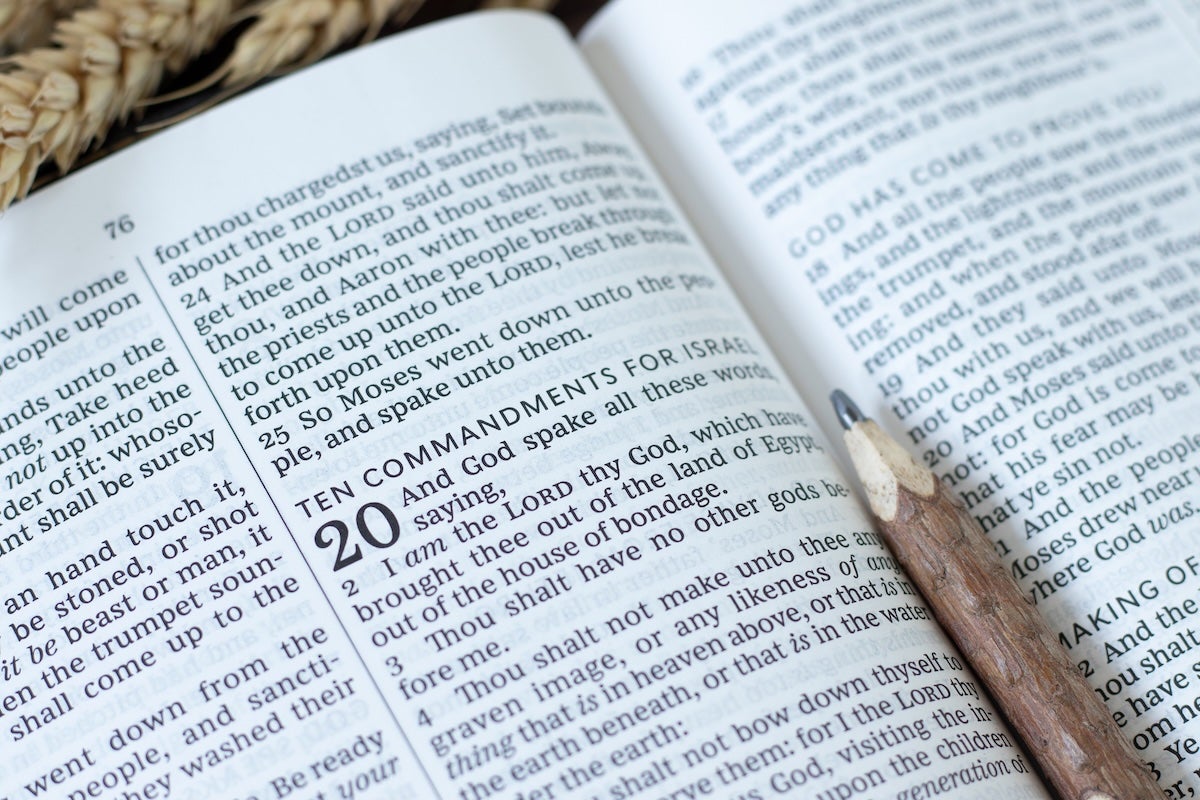 Ten commandments text in open holy bible book