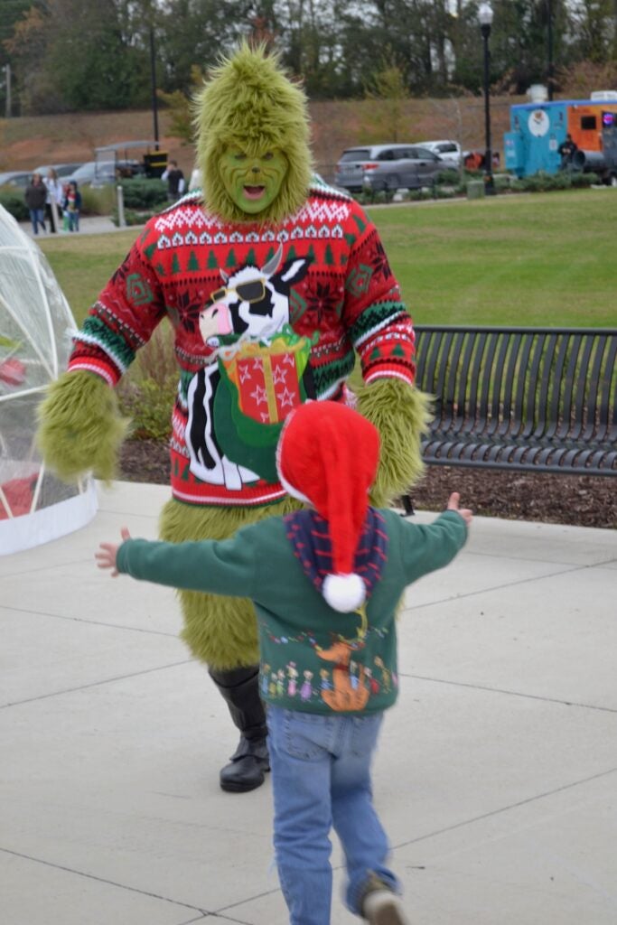 The Grinch had a good time meeting kids at the Christmas in Columbia County event prior to the tree lighting on Thursday, Dec. 4. Staff photo by Stephanie Hill