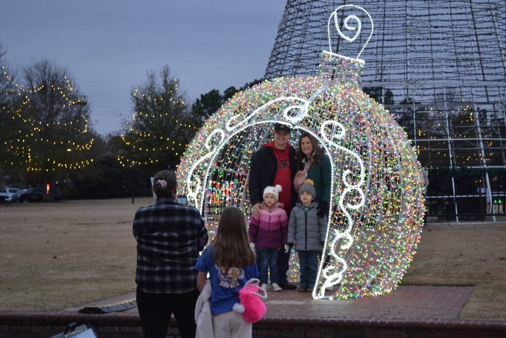 Families were all smiles as they posed for photos in giant ornaments at the Evans Towne Center Park. Staff photo by Stephanie Hill