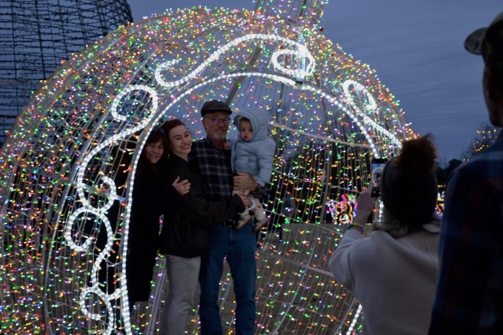 Families were all smiles as they posed for photos in giant ornaments at the Evans Towne Center Park. Staff photo by Stephanie Hill
