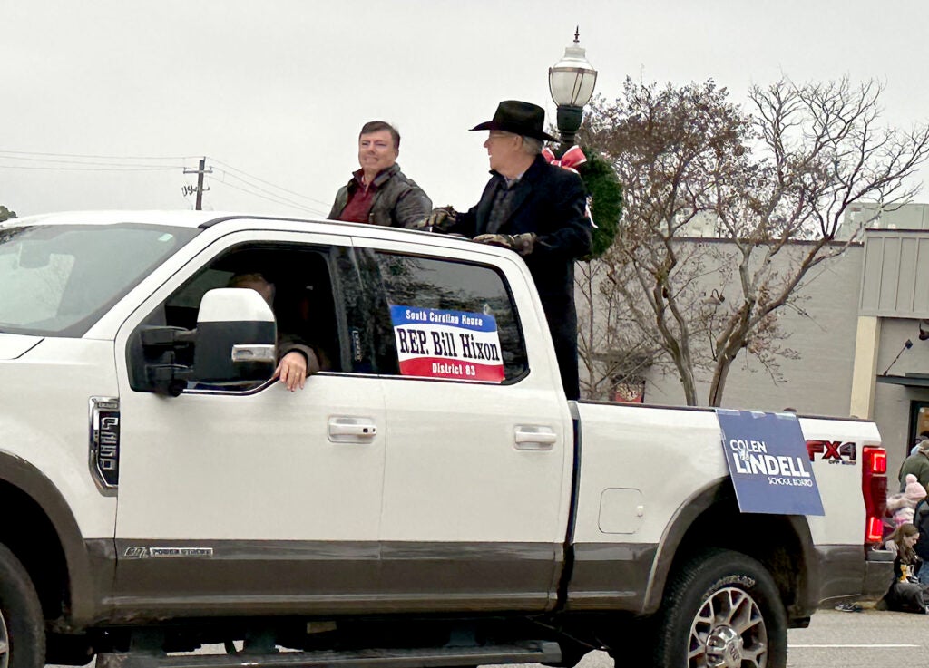 S.C. Rep. Bill Hixon and Aiken County school board candidate Colen Lindell campaigned together in the North Augusta Christmas Parade on Sunday. Staff photo by Susan McCord